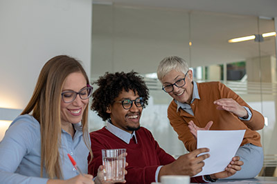 Our Clients, three people working together in office setting