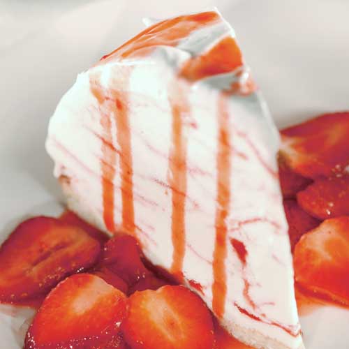 Slice of strawberry ice cream pie on a plate.