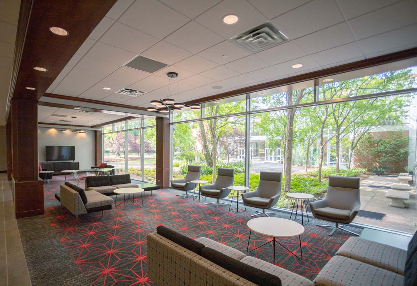 View of the Hotel lobby lounge area with windows along the back wall looking in the the Lumpkin Plaza.