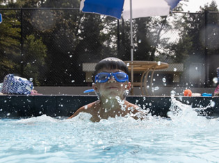Four-year-old Nolan Stillwell swims at Legion Pool.
