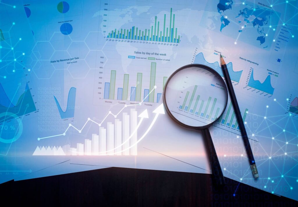 Magnifying glass and documents with analytics data lying on table , and digital virtual reality graph