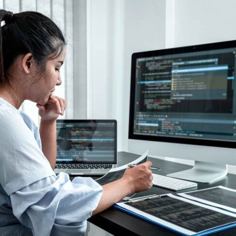 Female Programmer working in software javascript computer in IT office, Writing codes and data code website and coding database technologies to find solution to problem.