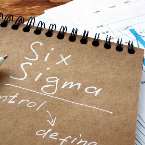 Six sigma sign as Lean Manufacturing concept. Notebook and papers.