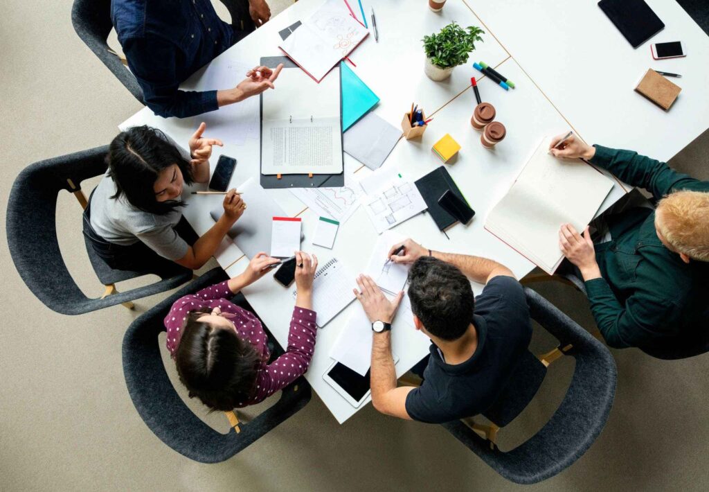Top view shot of business colleagues discussing over a new project in office.
