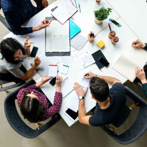 Top view shot of business colleagues discussing over a new project in office.