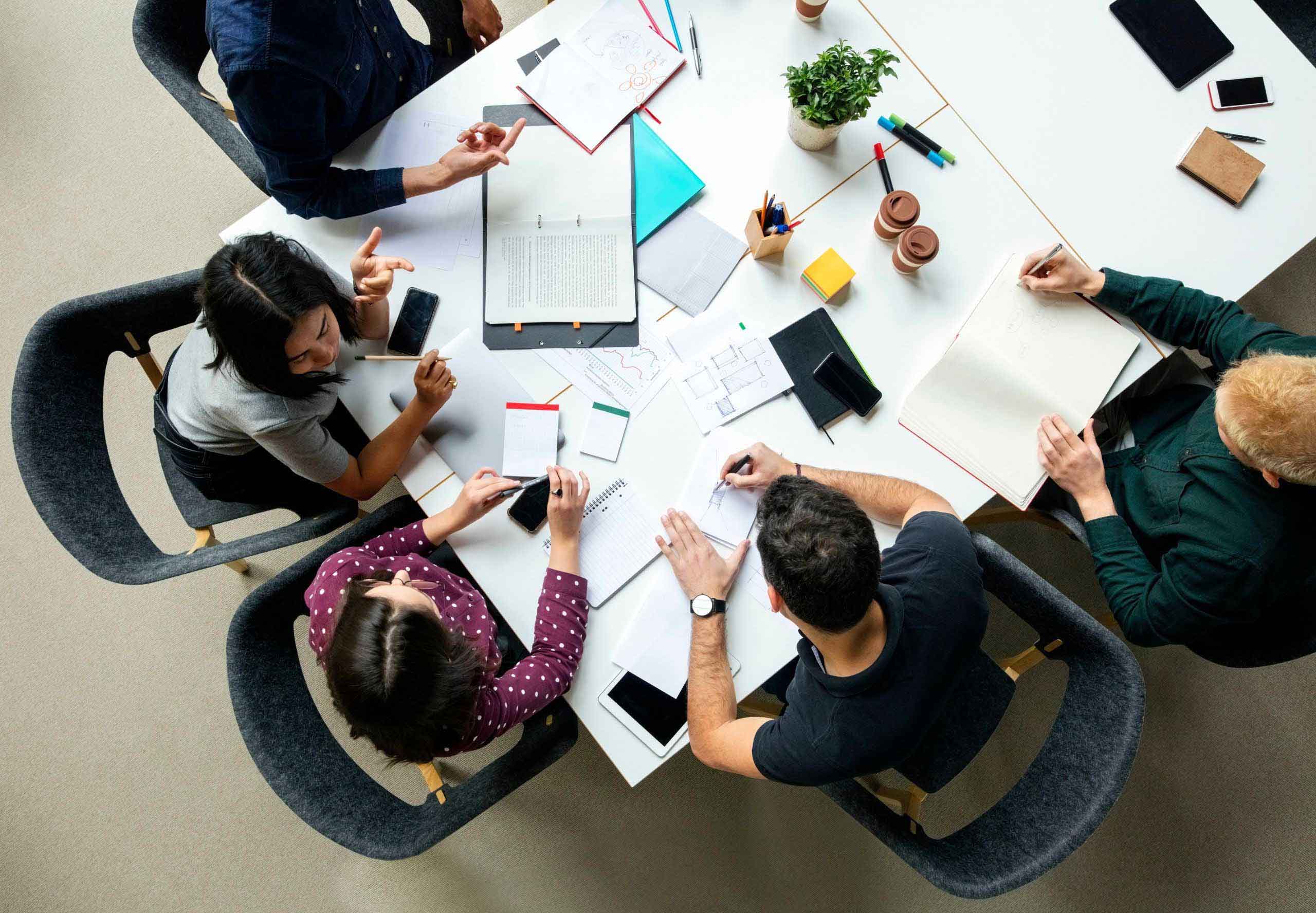 Top view shot of business colleagues discussing over a new project in office.