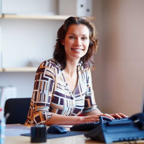 Portrait of a businesswoman at office desk with a computer