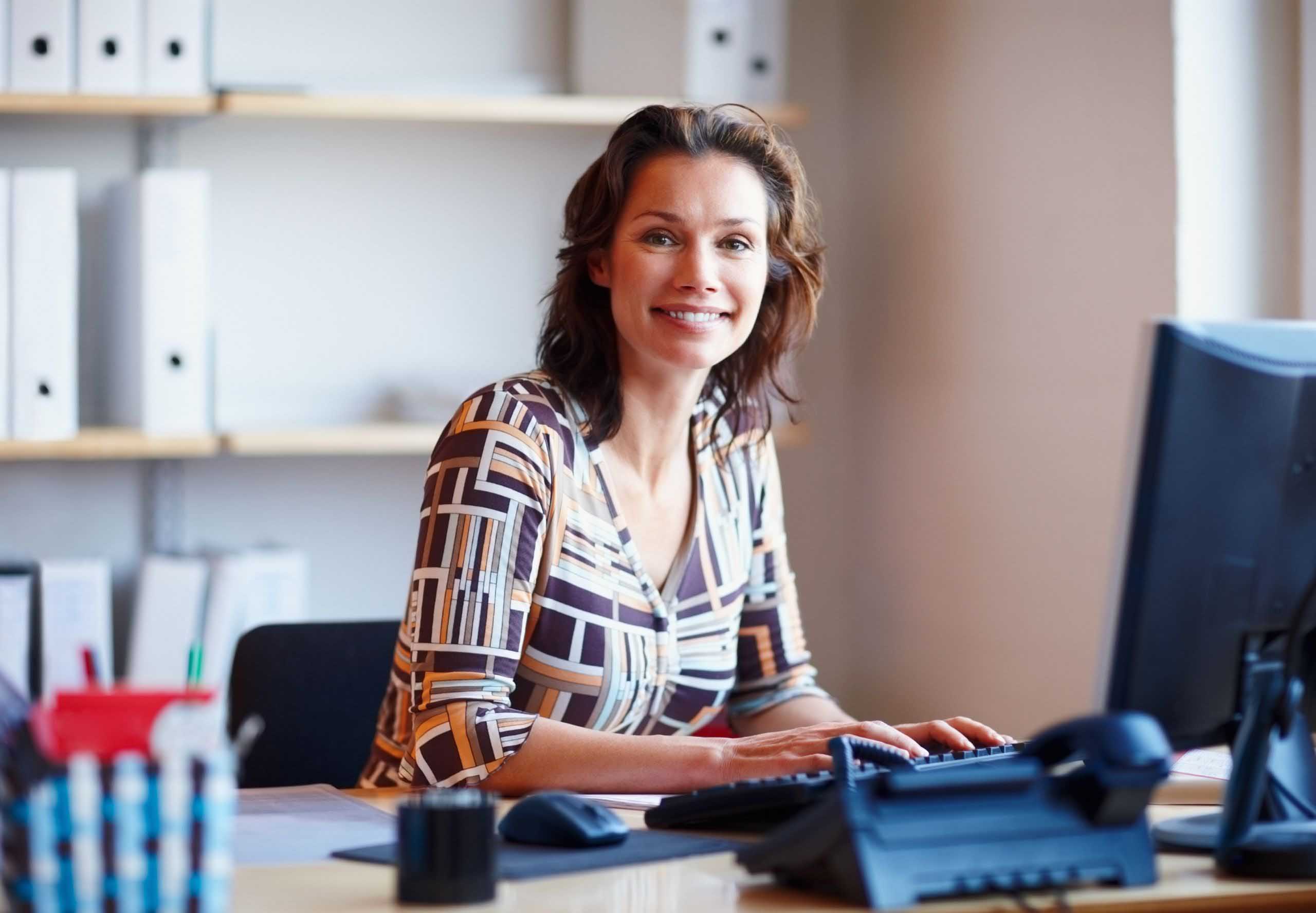 Portrait of a businesswoman at office desk with a computer