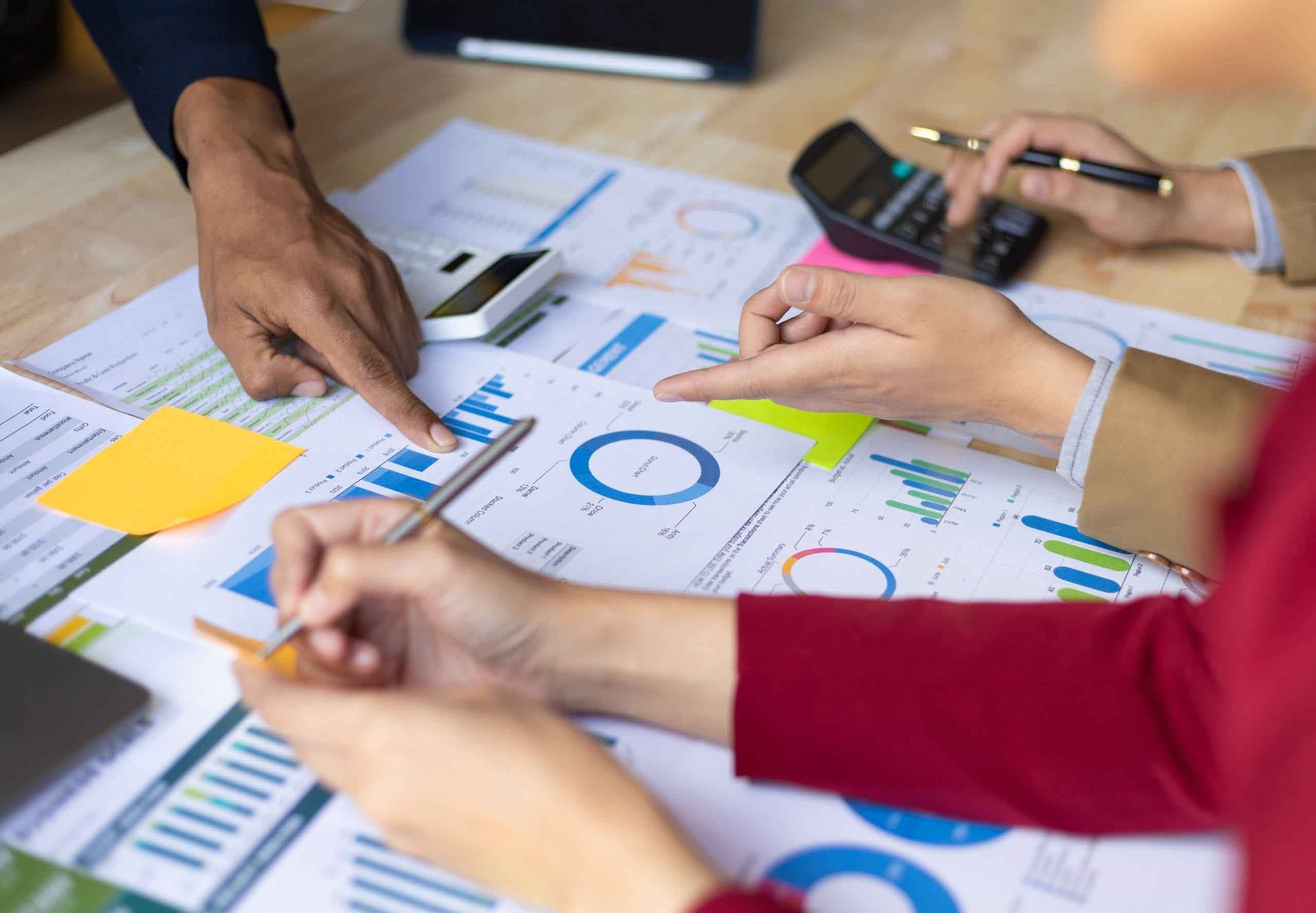 Business meeting, Financial consultants discuss investment growth chart analysis in company financial reports and are planning marketing business strategies.