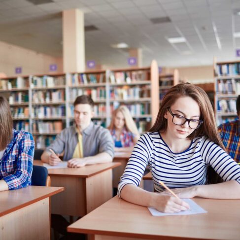 Serious student writing test at college