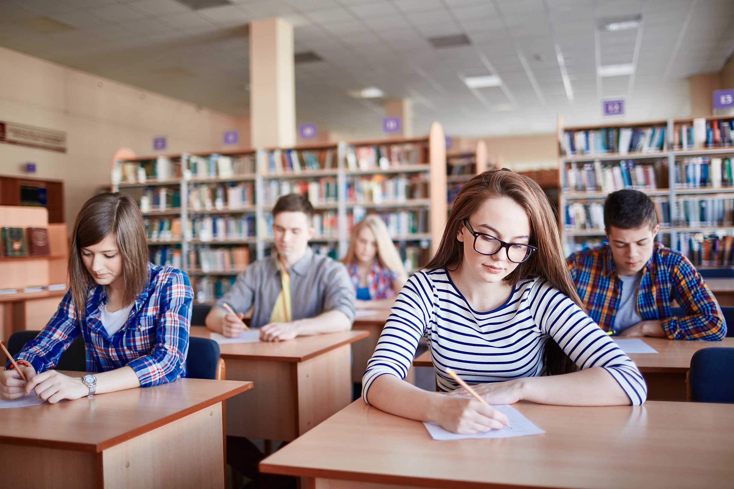 Serious student writing test at college