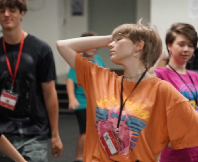 Students acting in a classroom.