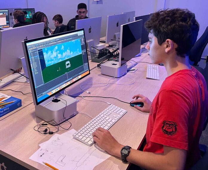 Student looking at a computer screen with an outdoor image
