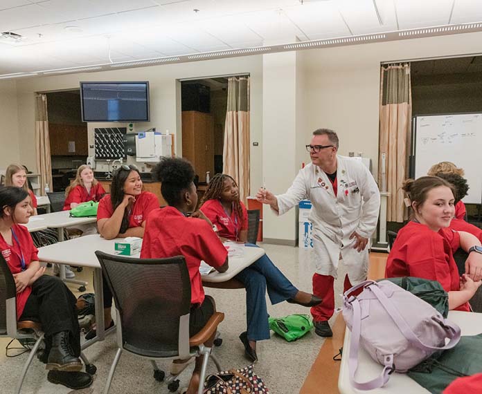 A doctor teaching a room full of students.