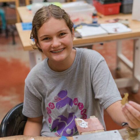 student holding a piece of metal
