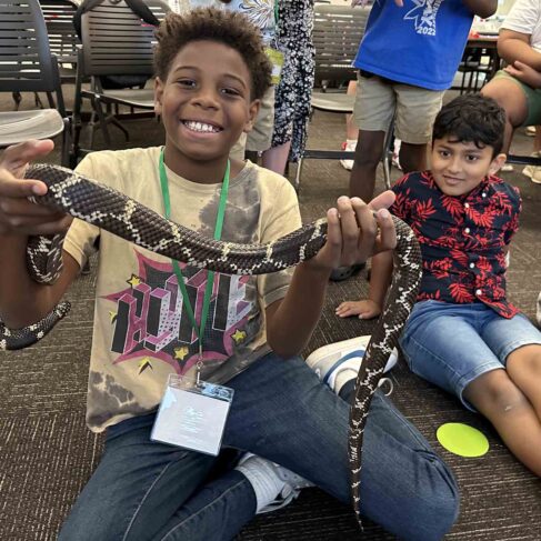 student holding a snake