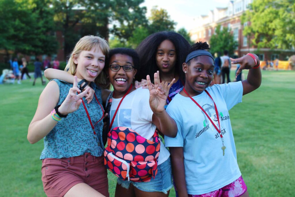 Four young students posing for the camera at Summer Academy