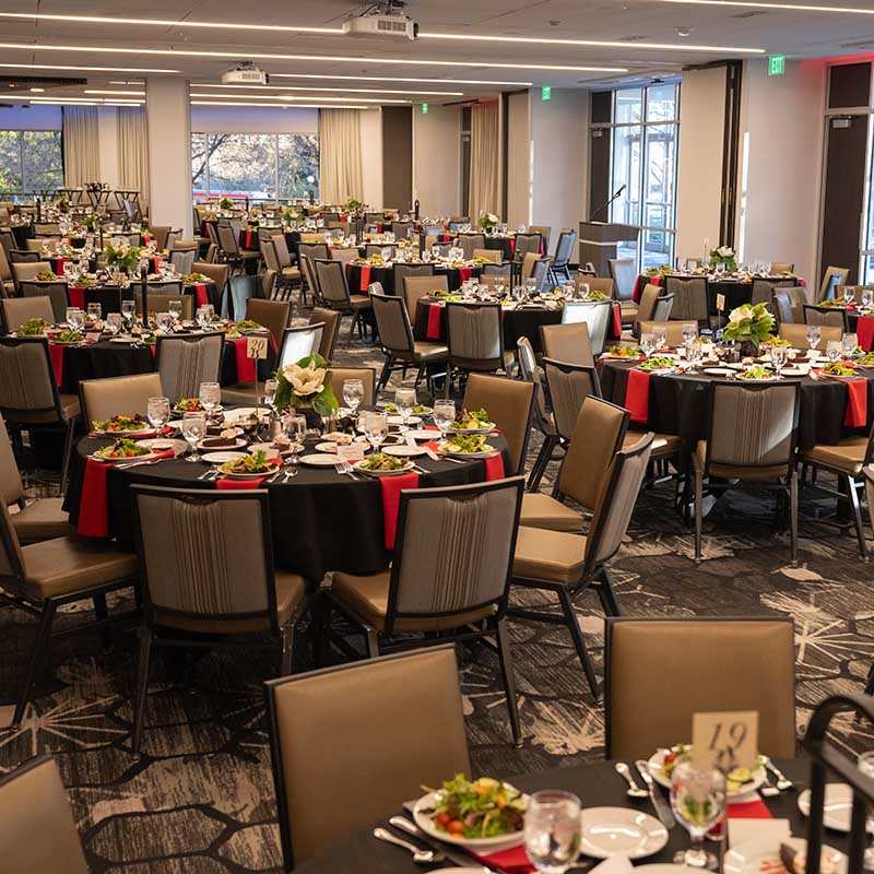 Magnolia Ballroom set up with plates of salad on all the tables.