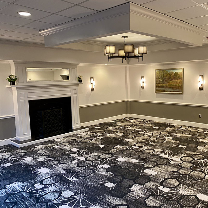 View of the Oak Room, space used for banquets, has a fireplace and pictures on the walls