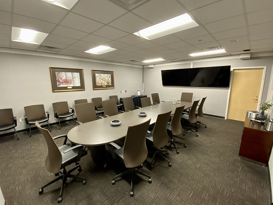 view of the University boardroom with chairs surrounding the main table.
