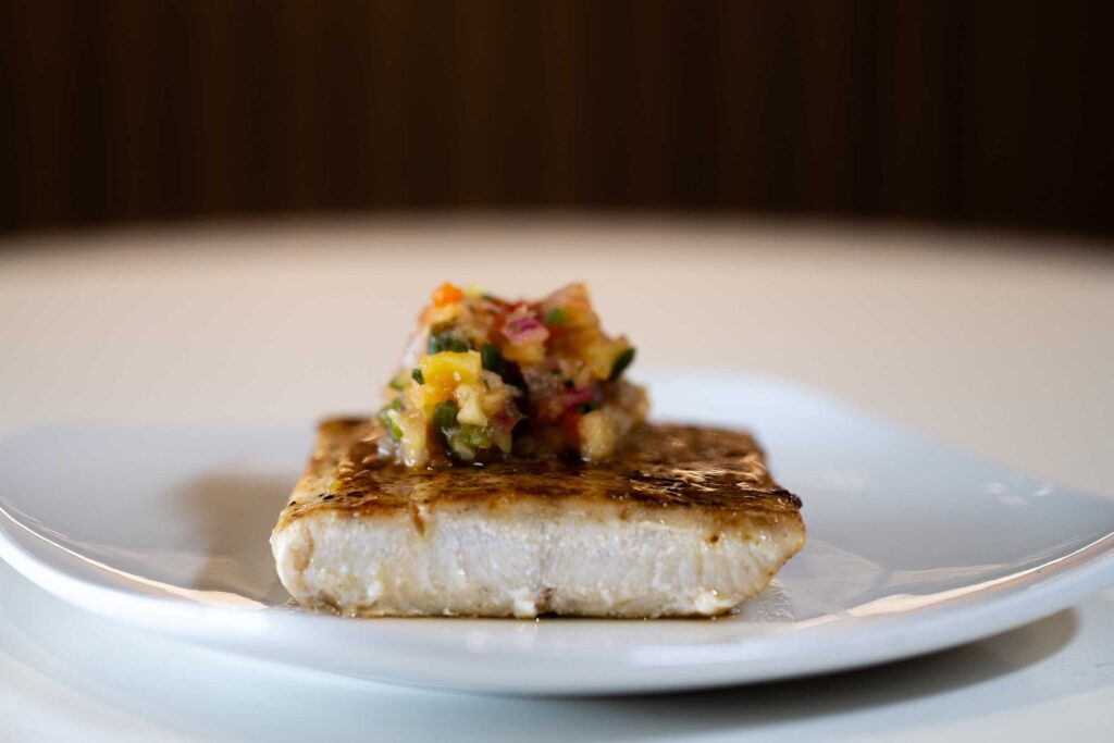 close up of mango Mahi on a white plate