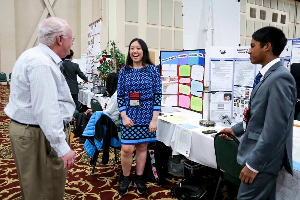 Student talking to a judge about her science project