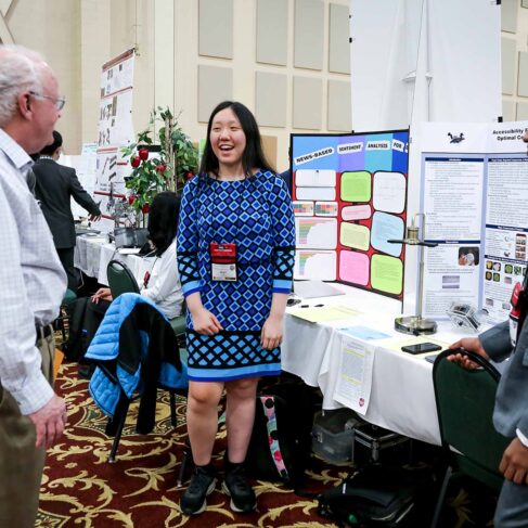 Student talking to a judge about her science project