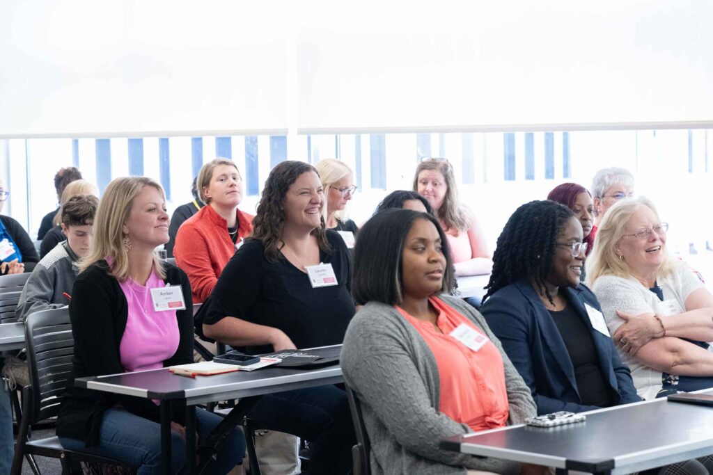 A group of people sitting in a classroom
