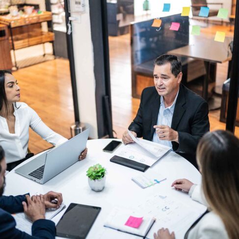 Businessman talking to coworkers on a meeting at office