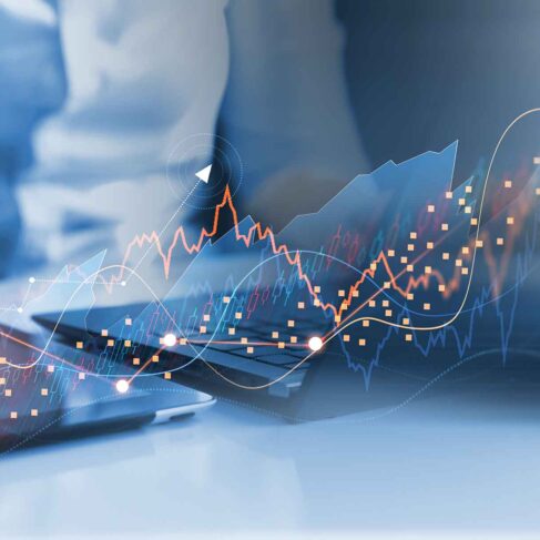 Businessman analyzing data of economic growth graph and progress of business on tablet and laptop.