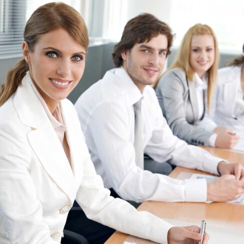 Four business colleagues sitting in a row and working together on a business presentation.