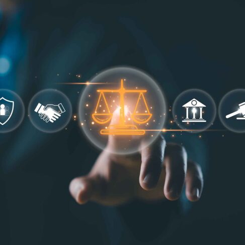 A suited legal professional touches virtual icons symbolizing law, justice, and legal services.