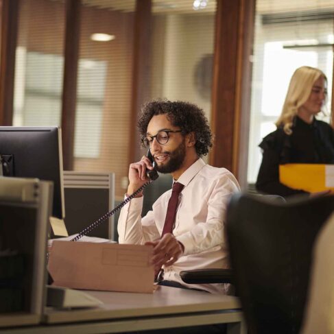 Man on a phone working in paralegal office