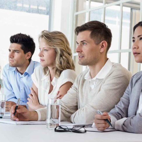 Casual business team listening during meeting in the office