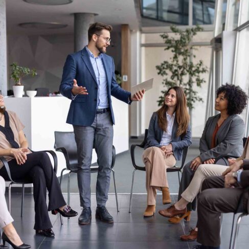 A business team gathered in a sleek office space for a meaningful discussion, showcasing collaboration and professionalism among group members.