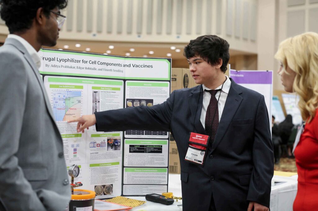 student showing his project to other people