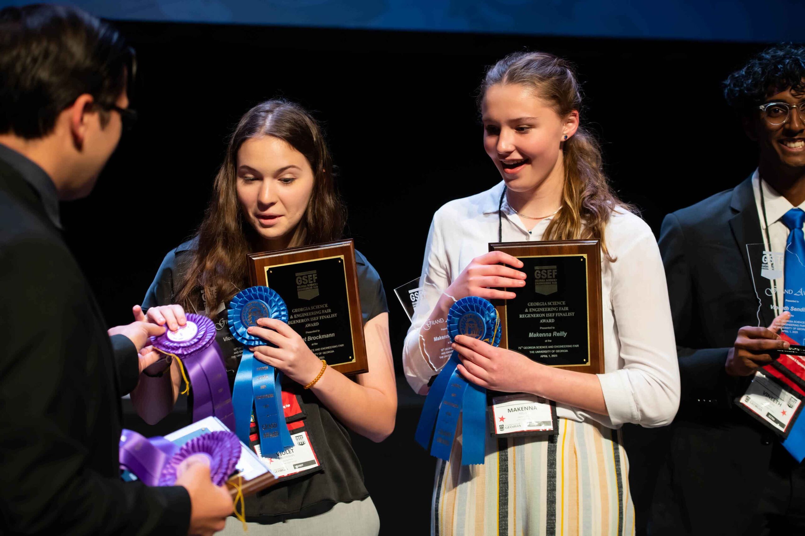 two female students accepting ribbons