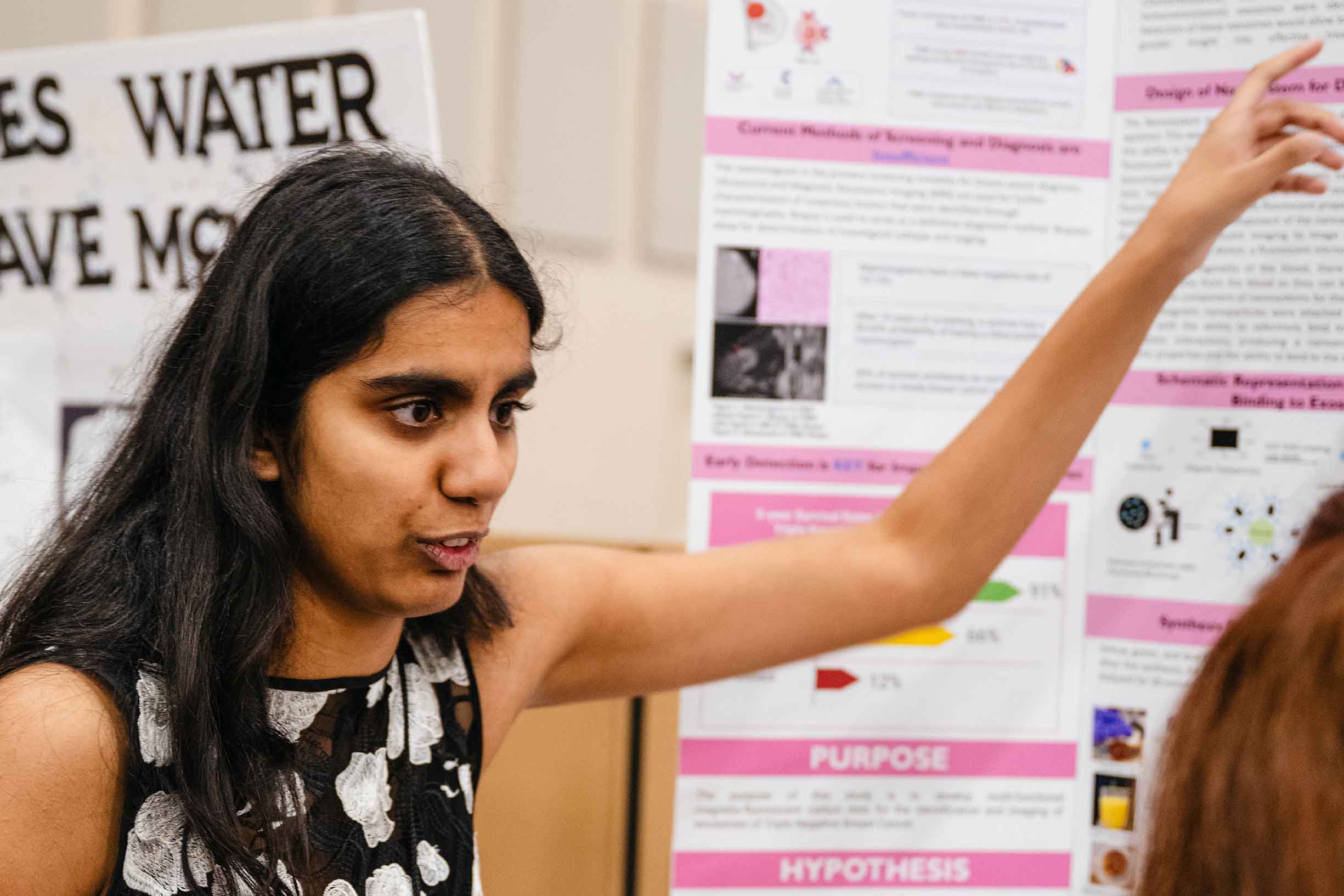 A science fair student explaining her project to a judge