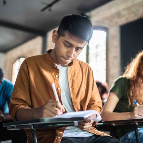 Focused student doing test during a class
