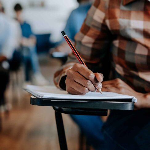 Student writing in the classroom
