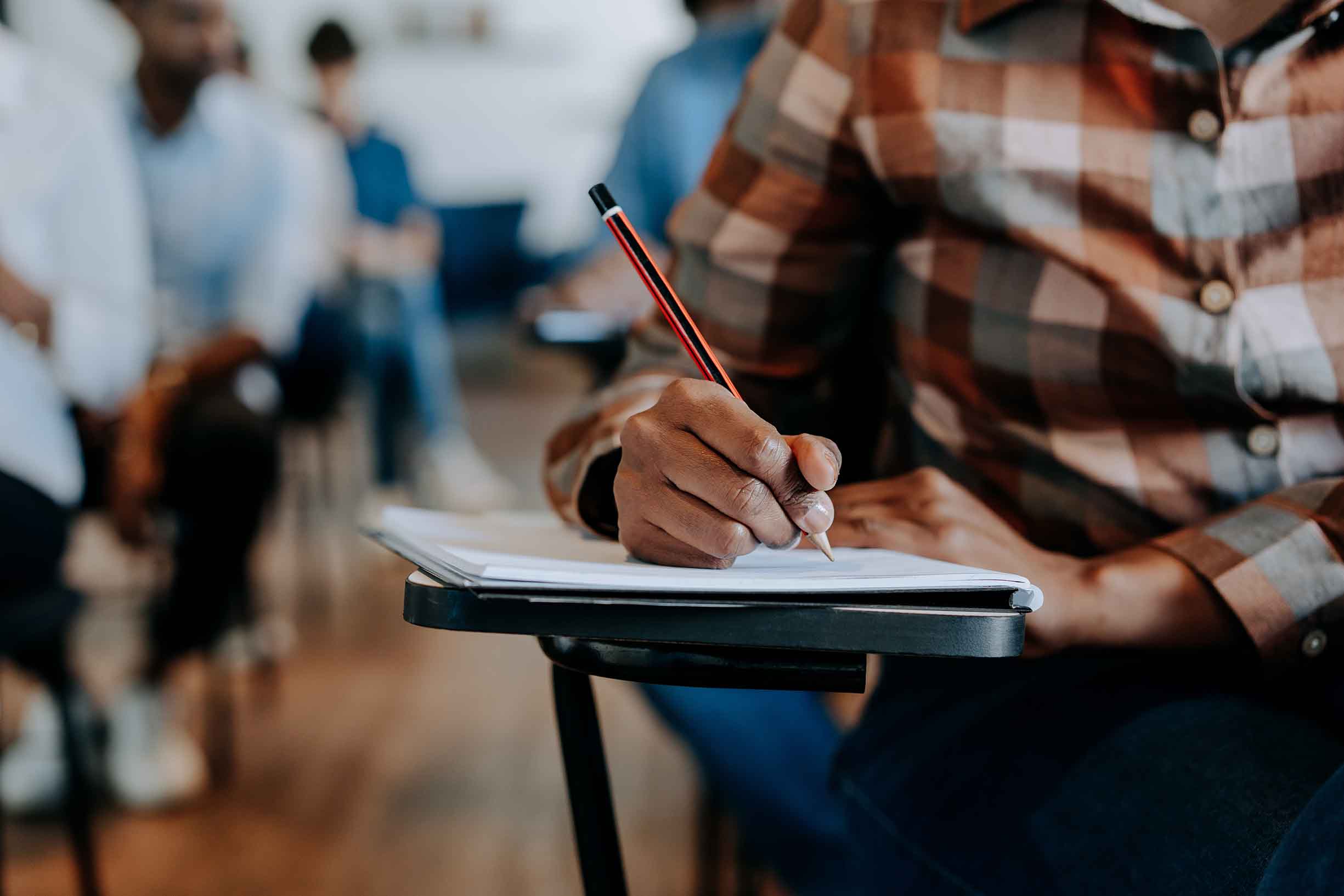 Student writing in the classroom