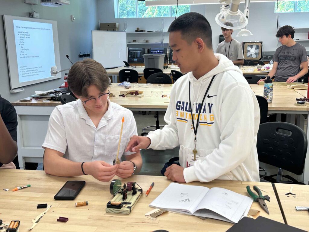 two students working on a engineering project during summer camp at UGA