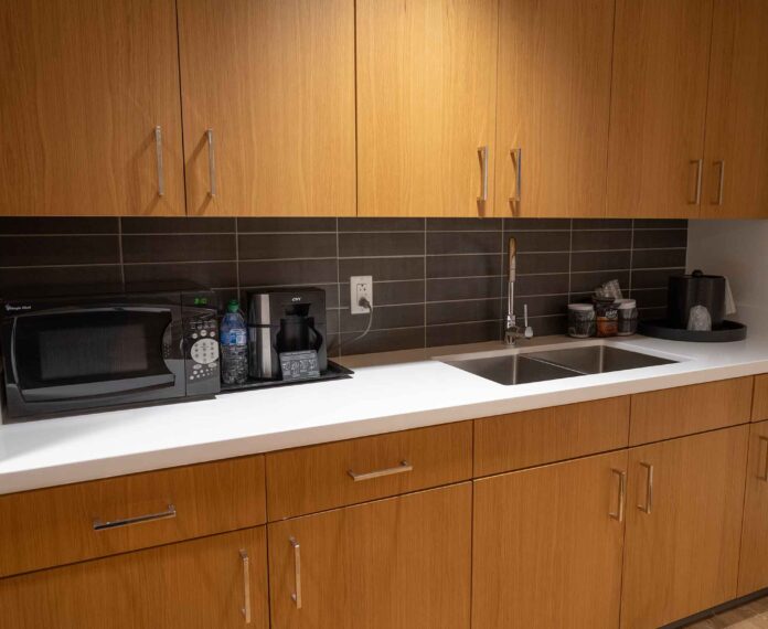View of cabinets, microwave, and sink in the Presidents King Suite