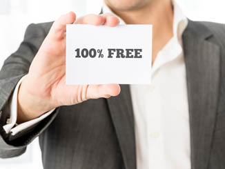 Closeup of salesman showing a white business card with 100% free sign.