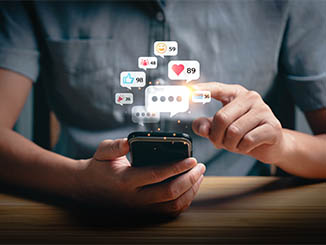 Social media interaction and online engagement concept with smartphone notifications. User touching screen to respond to likes, messages, and comments. Digital communication and network connection.
