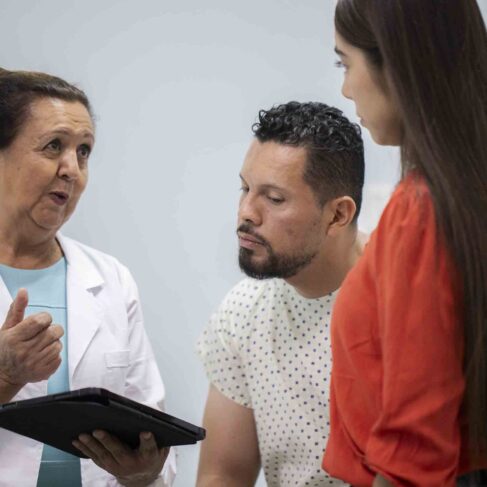 Doctor reviewing x-rays with patient and family member