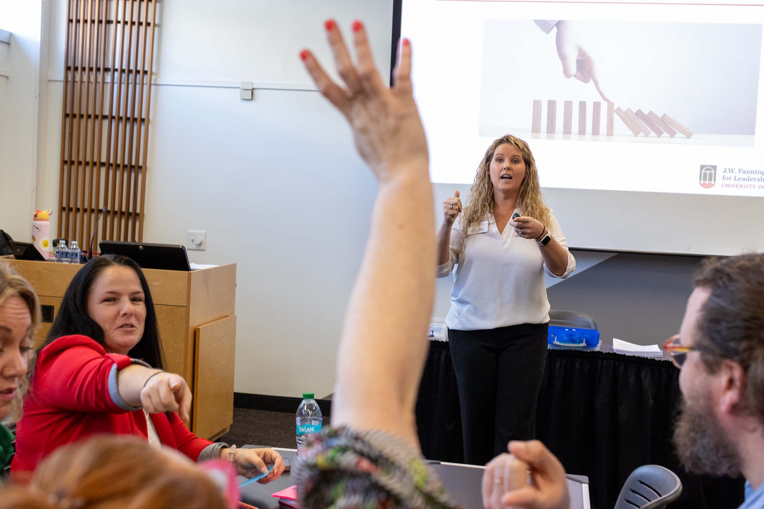 Someone is raising their hand wanting to ask the speaker a question about their presentation