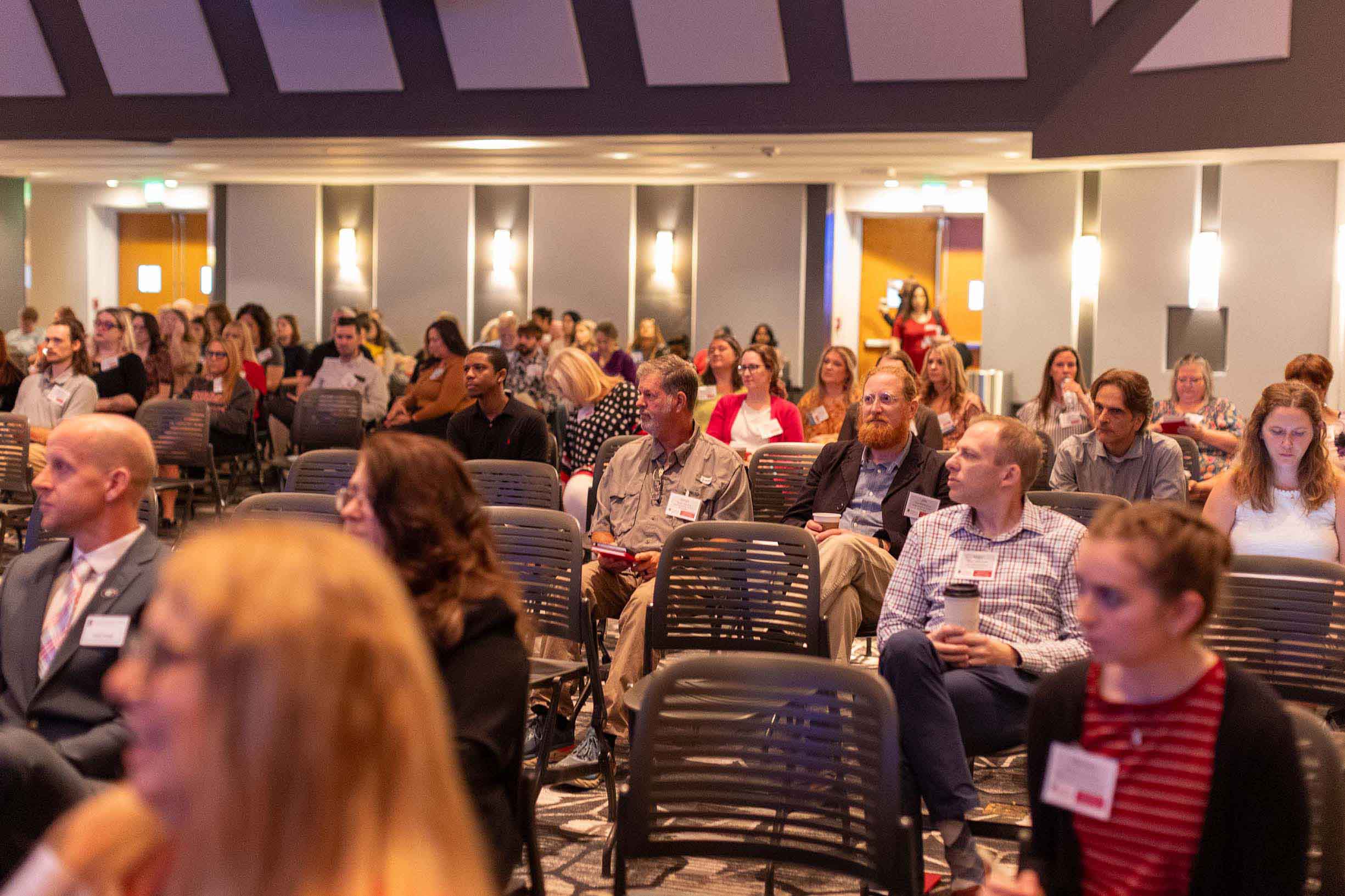 A group of people sitting on chairs in Mahler Hall