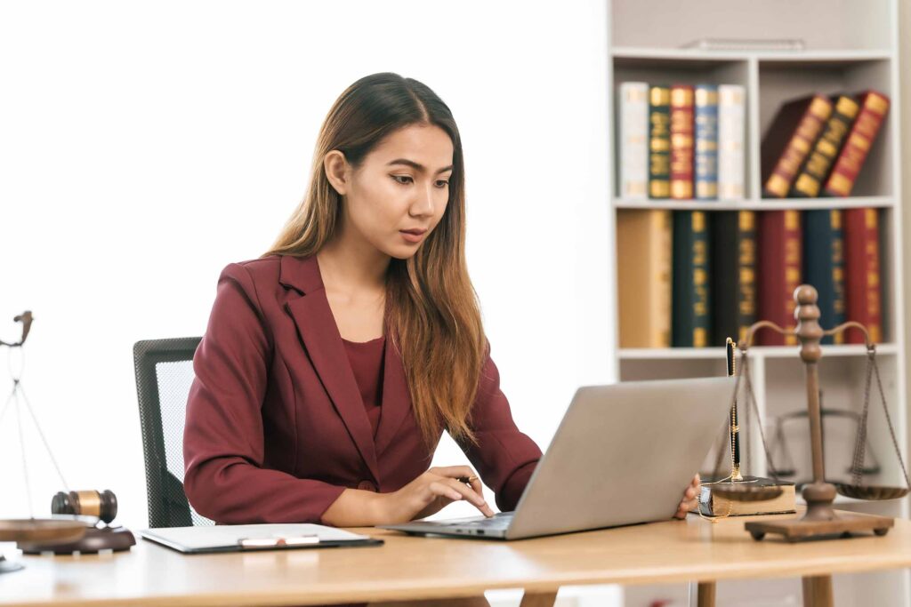 Young female lawyer reviewing legal documents at desk, embodying reliability, dedication in legal profession, reading announcement. Court convicting defendant according to criminal law