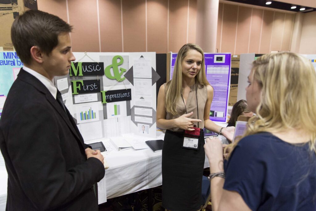 Eighteen year old senior Ryan D., left, of Mill Creek High School and his classmate eighteen year old senior Katie S. talk with judge Caroline J., a second year psychology masters student at UGA during judging on Friday afternoon at the Georgia Statewide Science and Engineering Fair held at the Classic Center in Athens, Ga.